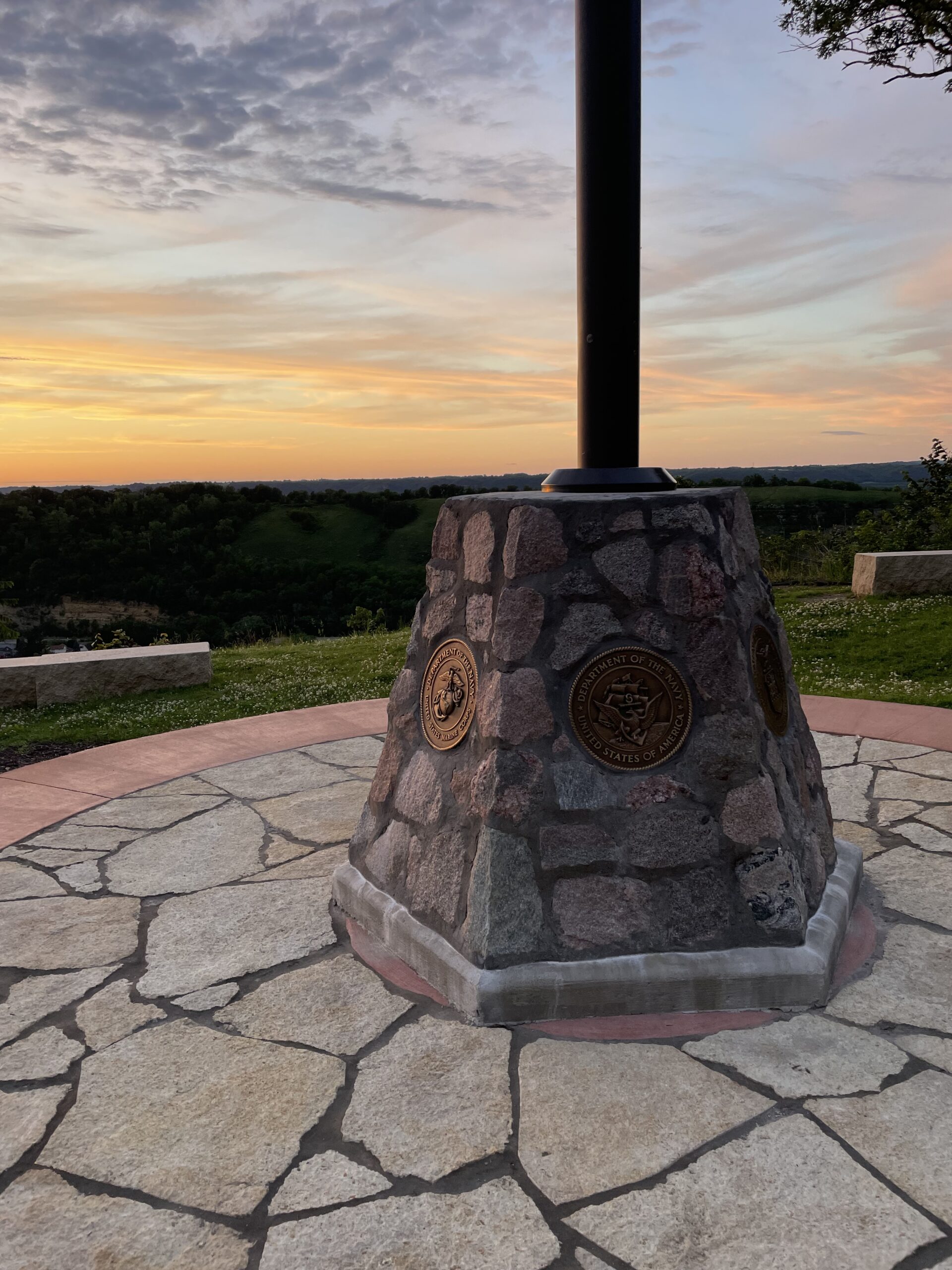 Photo of flagpole base recognizing the military branches of service
