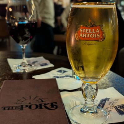 Photo of The Port in the St James Hotel with a wine glass and beer glass.