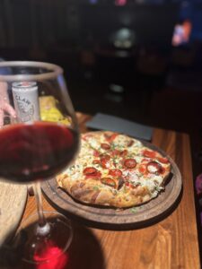 Photo of pizza and glass of wine at the Chatter Nook Bistro in Red Wing