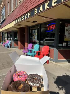 Photo of exterior of Hanisch Bakery in Red Wing MN with box of donuts